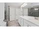 Bathroom featuring a dual sink vanity with quartz countertops, chrome fixtures, modern tiled shower, and neutral color palette at 2650 Turner Pines Dr, New Hill, NC 27562