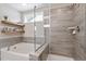 Bathroom featuring a modern soaking tub, frameless glass shower, floating shelves, and elegant gray tile work at 2650 Turner Pines Dr, New Hill, NC 27562