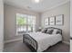 Bright bedroom with large window, plush carpet, and a modern black metal bed frame at 2650 Turner Pines Dr, New Hill, NC 27562