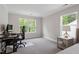 Well-lit bedroom featuring soft carpeting, neutral paint, and a large window offering natural light and green views at 2650 Turner Pines Dr, New Hill, NC 27562