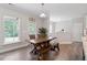 Charming dining area with a rustic wooden table, bench seating, and plenty of natural light at 2650 Turner Pines Dr, New Hill, NC 27562