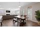 Inviting dining area adjacent to living space features rustic table and ample natural light at 2650 Turner Pines Dr, New Hill, NC 27562