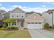 Charming two-story home with brick accents, manicured lawn, and a welcoming front porch with seating at 2650 Turner Pines Dr, New Hill, NC 27562