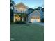 Charming two-story home featuring a well-manicured lawn, attached garage, and welcoming front porch at 2650 Turner Pines Dr, New Hill, NC 27562