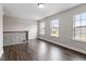 Bright hallway with dark, wide plank flooring, neutral paint, and large windows providing plenty of natural light at 2650 Turner Pines Dr, New Hill, NC 27562