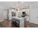 A bright kitchen with a large island, stainless steel appliances, and modern finishes at 2650 Turner Pines Dr, New Hill, NC 27562