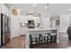 Bright kitchen features an island with seating, stainless steel appliances, and white cabinetry at 2650 Turner Pines Dr, New Hill, NC 27562