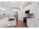 Modern kitchen featuring granite countertops, stainless steel appliances, and white cabinets at 2650 Turner Pines Dr, New Hill, NC 27562