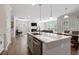 Open concept kitchen with granite counters and stainless appliances flows into the living and dining areas at 2650 Turner Pines Dr, New Hill, NC 27562