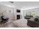 Spacious living room featuring a fireplace, plush seating, and plenty of natural light at 2650 Turner Pines Dr, New Hill, NC 27562