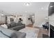 Open-concept living room flows seamlessly into a modern kitchen with stainless steel appliances at 2650 Turner Pines Dr, New Hill, NC 27562