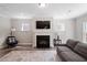 Inviting living room features a cozy fireplace, plush seating, and abundant natural light at 2650 Turner Pines Dr, New Hill, NC 27562