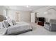 Cozy main bedroom with soft gray carpeting, neutral paint, and a sitting area with natural light from backyard views at 2650 Turner Pines Dr, New Hill, NC 27562