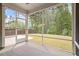 A view of a screened in porch leading to a grassy back yard at 2650 Turner Pines Dr, New Hill, NC 27562
