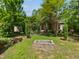 Spacious backyard featuring a stone fire pit and a view of the lovely brick home at 280 Dreamcatcher Trl, Youngsville, NC 27596