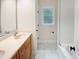 Bathroom featuring double sinks, tile floors, and tub shower combination at 280 Dreamcatcher Trl, Youngsville, NC 27596