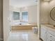 Bright bathroom featuring a tiled floor, tub, glass block window and tiled shower at 280 Dreamcatcher Trl, Youngsville, NC 27596
