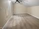 The attic bedroom features tan carpet, a ceiling fan, and a side window at 280 Dreamcatcher Trl, Youngsville, NC 27596