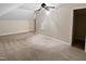 This attic bedroom features tan carpet and a ceiling fan at 280 Dreamcatcher Trl, Youngsville, NC 27596