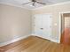 Empty bedroom with hardwood floors, neutral paint, and closet doors at 280 Dreamcatcher Trl, Youngsville, NC 27596