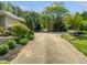 Long driveway with lovely garden beds on either side, leading to the home at 280 Dreamcatcher Trl, Youngsville, NC 27596