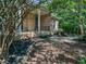 Brick home with a manicured lawn, black mulch, and covered front porch with columns at 280 Dreamcatcher Trl, Youngsville, NC 27596