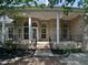 The home boasts a brick exterior, white columns, and an inviting covered front porch at 280 Dreamcatcher Trl, Youngsville, NC 27596