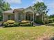 Beautifully landscaped home featuring a classic brick facade, manicured shrubs and lawn at 280 Dreamcatcher Trl, Youngsville, NC 27596