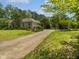 Classic brick home with a large lawn, beautiful landscaping, and a long driveway at 280 Dreamcatcher Trl, Youngsville, NC 27596