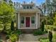 Charming home with a columned front porch, brick stairs, and a red door at 280 Dreamcatcher Trl, Youngsville, NC 27596