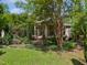 Charming brick home featuring a covered front porch with beautiful columns and lush landscaping at 280 Dreamcatcher Trl, Youngsville, NC 27596