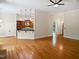 Open-concept living area with hardwood floors leading to the kitchen at 280 Dreamcatcher Trl, Youngsville, NC 27596