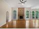 Spacious living room with hardwood floors and a stone fireplace at 280 Dreamcatcher Trl, Youngsville, NC 27596