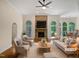 Bright living room featuring a stone fireplace and stylish furnishings at 280 Dreamcatcher Trl, Youngsville, NC 27596