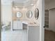 Well-lit main bathroom showcasing the dual sinks, tiled floor, and entry to the walk-in closet at 280 Dreamcatcher Trl, Youngsville, NC 27596