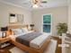 Comfortable main bedroom with plush bed, ceiling fan, and large window at 280 Dreamcatcher Trl, Youngsville, NC 27596