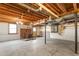 Open basement space with exposed duct work, brick fireplace, and concrete floor at 2917 Trail Six, Burlington, NC 27215