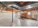 Unfinished basement space with exposed duct work, brick fireplace, and concrete floor at 2917 Trail Six, Burlington, NC 27215