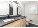 Bathroom featuring double sinks, black countertops, and modern fixtures at 2917 Trail Six, Burlington, NC 27215