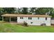 Rear exterior view of a home featuring a carport, patio, and well-maintained lawn at 2917 Trail Six, Burlington, NC 27215
