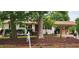 Charming single story home with white painted brick and a covered parking area with a red storage shed at 2917 Trail Six, Burlington, NC 27215