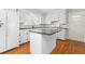 Clean kitchen equipped with white cabinetry, a functional island, and modern appliances for an inviting culinary experience at 2917 Trail Six, Burlington, NC 27215