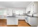 Bright kitchen features white cabinets, an island, and modern appliances, providing a clean and functional cooking space at 2917 Trail Six, Burlington, NC 27215