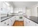 Traditional kitchen featuring white cabinets, black countertops, hardwood floors and modern appliances at 2917 Trail Six, Burlington, NC 27215
