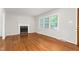 Inviting living room with hardwood floors, fireplace, and plenty of natural light streaming through the windows at 2917 Trail Six, Burlington, NC 27215