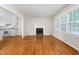Bright living room featuring a fireplace, hardwood floors, and large windows providing ample natural light at 2917 Trail Six, Burlington, NC 27215