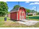 Red wooden outbuilding on a sunny lot with other outbuildings nearby at 2917 Trail Six, Burlington, NC 27215