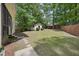 Spacious backyard featuring mature trees and a shed at 300 Hutchins Dr, Garner, NC 27529