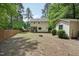 Spacious backyard featuring mature trees, privacy fence, and shed at 300 Hutchins Dr, Garner, NC 27529