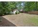 Large backyard featuring a shed, fire pit, and privacy fence at 300 Hutchins Dr, Garner, NC 27529